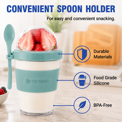 Ultimate Yogurt Parfait Cup with a teal silicone sleeve and matching spoon, shown on a kitchen counter with strawberries inside and feature callouts including durable materials, food grade silicone, and BPA-free.